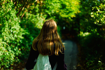 Naklejka premium Young woman walking in the woods on an autumn day