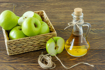 Zero waste concept. No plastic concept. Minimal style. Beige water hyacinth box with ripe green apples on wooden background.