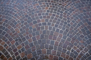 wet road pavement in gray porphyry cubes. background