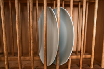 Plates in a rack at home in domestic kitchen