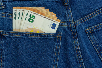 European money euro in jeans pocket background. Cash, money is in the pocket of blue jeans. Close-up