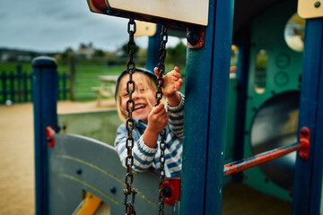 Preschooler playing with pulley at the playground