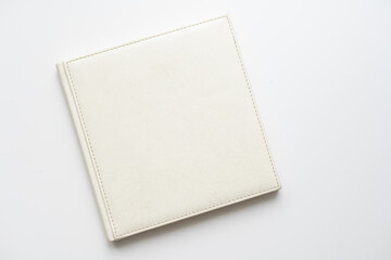 The book with a white cover on white background