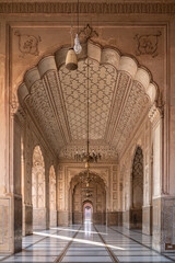 Beautiful row of aligned arches behind the facade of ancient Badshahi mosque built by mughal...