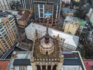 House with a five-pointed star on a spire in the center of Kiev. Aerial drone view. Winter cloudy morning.