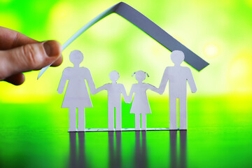 Cutout paper chain family with the protection of cupped hands, concept for security and care