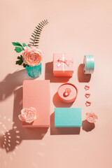 Festive geometric arrangement of gift boxes and flowers in pastel colors with sunny shadows Congratulations on Women's Day and birthday. Romantic mockup concept for wedding invitation