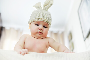 The little baby is lying on the crib. Newborn.