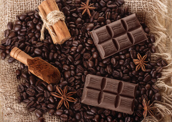 chocolate, coffee beans, anise  on wooden background  