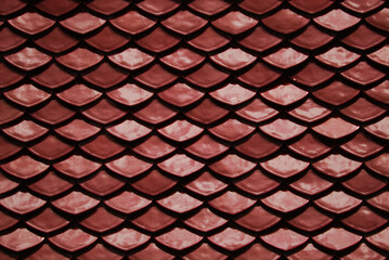 Red Abstract Background of earthenware tiles or calls tiles consists of fish scales on the roof of temple bangkok thailand - Backdrop Resource Design