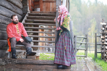 Traditional Slavic rituals in the rustic style. Outdoor in summer. Slavic village farm. Peasants in elegant robes.