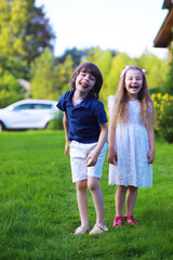 Fototapeta premium Young large family on a summer morning walk. Beautiful mother with children is playing in the park.