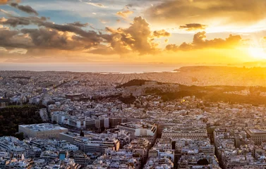 Fotobehang Panoramic view to the skyline of Athens, Greece, with Acropolis, Parthenon Temple, the Syntagma parliament and Piraeus harbour in the background during golden sunset time © moofushi