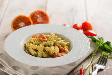 pasta fusilli with basil pesto and orange grated peel