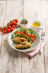 rolled sword fish with capers arugula and tomatoes salad