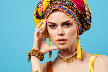 pretty woman multicolored turban decoration fashion close-up blue background