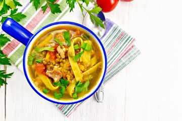 Soup with mung and noodles in blue bowl on board top