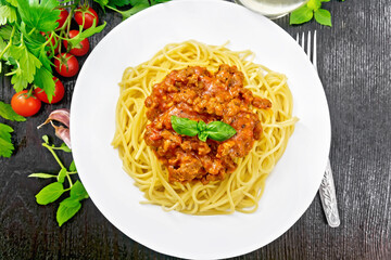 Spaghetti with bolognese on dark board top