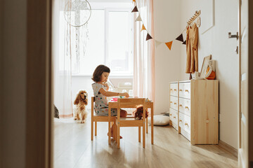 Little girl playing children tableware