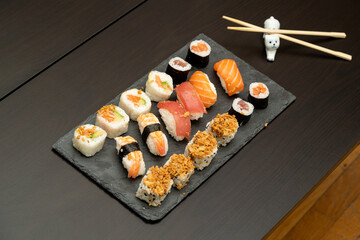 Japanese sushi food. Maki ands rolls with tuna, salmon, shrimp, crab and avocado. Close up and top view of assorted sushi. 