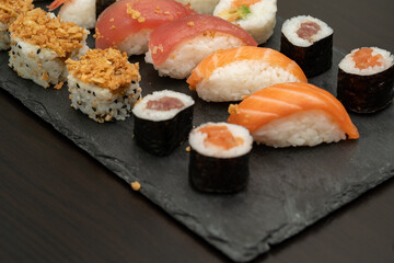 Japanese sushi food. Maki ands rolls with tuna, salmon, shrimp, crab and avocado. Close up and top view of assorted sushi. 