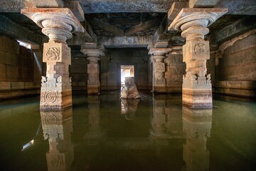 Flooded dark interior space of Prasanna Virupaksha temple, also known as Underground Shiva Temple in Hampi, Karnataka, India