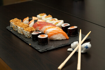Japanese sushi food. Maki ands rolls with tuna, salmon, shrimp, crab and avocado. Close up and top view of assorted sushi. 