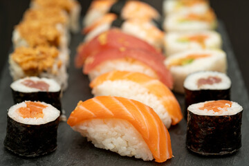 Japanese sushi food. Maki ands rolls with tuna, salmon, shrimp, crab and avocado. Close up and top view of assorted sushi. 