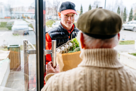 Fresh Groceries and Food Delivery for Elderly People. Old Senior Man Receiving Parcel. Meal Basket as Social Help and Support. Volunteerism. Online Order Service during quarantine.