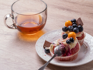 red muffins with blueberries and chocolate on a wooden table. Tea and muffins for breakfast. Delicious breakfast at home. High quality photo