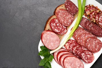 Meat plate with cold smoked sausages, sliced salami. Copy space. view from above