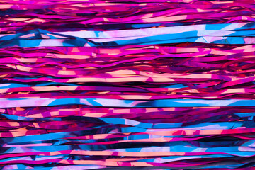 Abstract neon pink and blue background. New Year's tinsel. Active lines.