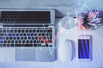 Multi exposure of forex graph drawing over desktop background with computer. Concept of financial analysis. Top view.