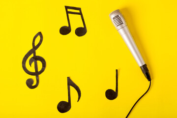 musical notes and microphone on a yellow background.