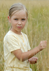Cute blonde girl on a meadow