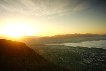 Rising sun  over the mountain with fog on the valley
