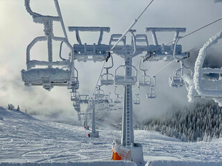 Thick ice covers the stalled chairlift at a closed ski resort in Slovenia.
