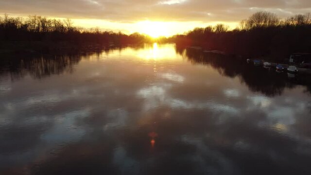 Flying backwards over Ticino river at sunset at Casa sul fiume beach, Pavia, Italy