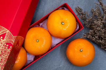 Lunar New Year (Chinese New Year) concept.  - Mandarin oranges in red box and flower