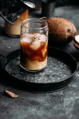 Iced coffee and coconut milk in a transparent glass