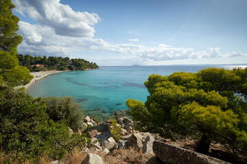 Fototapeta na wymiar Seascape with sandy beach and turquoise waters on Sythonia, Halkidiki Peninsula, Greece