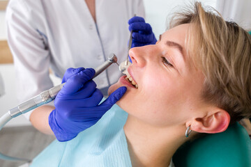 Woman at the dentist consultation. Checking and dental treatment in a clinic