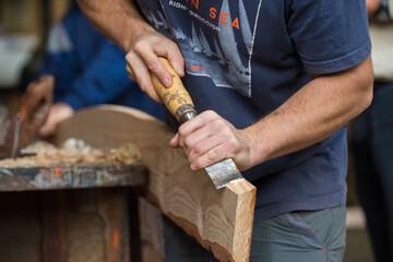carpenter working on a wooden board