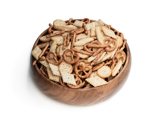 Crunchy mix of pretzels and crackers in wooden bowl isolated on white