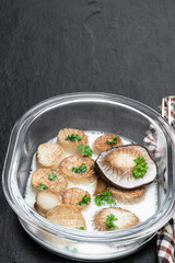 King oyster mushroom scallops with cream sauce on black stone background