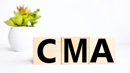 Acronym CMA Competitive Market Analysis.text on wood cubes, white background