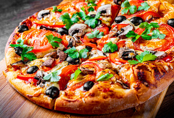 sliced Pizza with Mozzarella cheese, Tomatoes, pepper, olive, mushrooms, Spices and Fresh leaf....