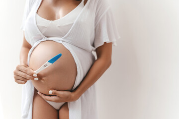 Pregnant Woman holding pregnancy test, New life and new family concept.