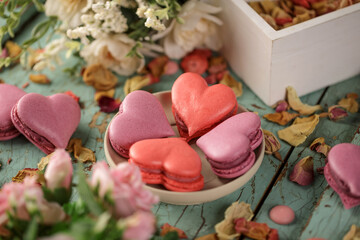 Heart shaped macarons on a wooden background
