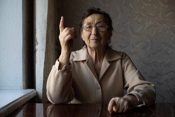 Senior woman pointing with finger